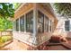 The corner of a sunroom featuring large windows and access to a brick-paved yard at 225 Vance St, Chapel Hill, NC 27516