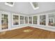 Light-filled sunroom with multiple windows, hardwood floors, and access to the outdoors at 225 Vance St, Chapel Hill, NC 27516