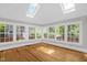 Bright sunroom featuring hardwood floors and multiple windows allowing ample natural light at 225 Vance St, Chapel Hill, NC 27516