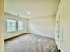 A bright bedroom showcases neutral carpeting, large windows, and a door to an attached closet at 23 Rolling Banks Dr, Louisburg, NC 27549