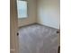 Neutrally decorated bedroom with carpet, window, and closet space at 23 Rolling Banks Dr, Louisburg, NC 27549