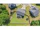 Aerial view of a home with a fenced yard, garden, deck, trampoline, and surrounding greenery at 232 Randleman Ct, Holly Springs, NC 27540