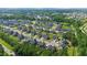Expansive aerial view of a well-planned residential community with neat rows of houses and green spaces at 232 Randleman Ct, Holly Springs, NC 27540