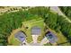Aerial view of a home with a large backyard, trampoline, and surrounding greenery in a residential area at 232 Randleman Ct, Holly Springs, NC 27540
