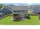 Two-story home's back exterior featuring a deck, walkout basement, and well-maintained lawn at 232 Randleman Ct, Holly Springs, NC 27540