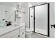 Bright bathroom boasts a glass shower, and white vanity offering a clean and modern aesthetic at 232 Randleman Ct, Holly Springs, NC 27540