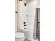 Bright bathroom featuring a tiled shower and tub, complete with sleek, modern fixtures at 232 Randleman Ct, Holly Springs, NC 27540