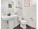 Bright powder bath features a pedestal sink, sleek fixtures, and modern finishes for a sophisticated look at 232 Randleman Ct, Holly Springs, NC 27540