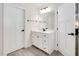 Bright bathroom with a white vanity, marble countertop, and modern fixtures at 232 Randleman Ct, Holly Springs, NC 27540