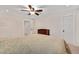 Neutral bedroom features neutral carpet, ceiling fan and adjacent door to hallway at 232 Randleman Ct, Holly Springs, NC 27540