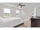 Light-filled main bedroom features large windows, neutral carpet, and an en-suite bathroom at 232 Randleman Ct, Holly Springs, NC 27540