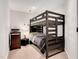 Bedroom features a dark wood bunk bed, a dresser, and a cozy atmosphere for restful nights at 232 Randleman Ct, Holly Springs, NC 27540