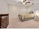 Cozy bedroom with neutral carpet, updated ceiling fan, and a convenient side table at 232 Randleman Ct, Holly Springs, NC 27540