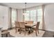 Cozy dining room featuring a wooden table with upholstered chairs and natural light from the windows at 232 Randleman Ct, Holly Springs, NC 27540