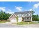 Two-story home with stone accents, a charming front porch with swing, a manicured lawn and a two-car garage at 232 Randleman Ct, Holly Springs, NC 27540