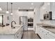 Modern kitchen with stainless steel appliances, granite counters, white cabinets, and a double wall oven at 232 Randleman Ct, Holly Springs, NC 27540