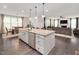 Large kitchen island with granite countertop, stainless steel dishwasher, and ample storage at 232 Randleman Ct, Holly Springs, NC 27540