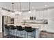 Granite countertop island featuring stainless steel appliances, barstool seating and modern pendant lighting at 232 Randleman Ct, Holly Springs, NC 27540