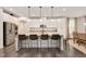 Bright kitchen featuring a large island with seating, stainless steel appliances, and modern pendant lighting at 232 Randleman Ct, Holly Springs, NC 27540