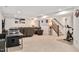 Expansive entertaining area includes comfortable seating, gym equipment, and stairs to the upper level at 232 Randleman Ct, Holly Springs, NC 27540