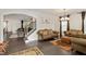 Elegant living room featuring hardwood floors, comfortable sofas, and decorative lighting fixtures and view to staircase at 232 Randleman Ct, Holly Springs, NC 27540