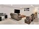 Relax in the cozy living room featuring leather recliners and a large flat-screen TV at 232 Randleman Ct, Holly Springs, NC 27540