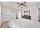 Bright primary bedroom boasts neutral carpet, a ceiling fan, and an adjacent ensuite bathroom at 232 Randleman Ct, Holly Springs, NC 27540