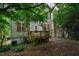 Backyard view of the home with a small deck and lush greenery at 244 Sweet Bay Pl, Carrboro, NC 27510