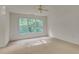 Bright bedroom with a ceiling fan and a large window overlooking a wooded area at 244 Sweet Bay Pl, Carrboro, NC 27510