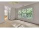 A carpeted bedroom with large window and attached bathroom, creating a private space at 244 Sweet Bay Pl, Carrboro, NC 27510