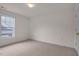 A cozy bedroom features neutral carpeting and a large window at 244 Sweet Bay Pl, Carrboro, NC 27510