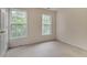 Bright bedroom featuring carpeted floors and two large windows offering an outdoor view at 244 Sweet Bay Pl, Carrboro, NC 27510