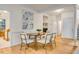 Elegant dining room with hardwood floors, wainscoting and view into the kitchen at 244 Sweet Bay Pl, Carrboro, NC 27510