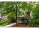 Exterior view of the house surrounded by mature trees and well-maintained landscaping at 244 Sweet Bay Pl, Carrboro, NC 27510
