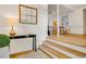 Bright foyer with hardwood floors, console table, lamp, decorative mirror and view into dining area at 244 Sweet Bay Pl, Carrboro, NC 27510