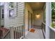 Inviting front porch with neutral siding, painted door, and stylish outdoor lighting at 244 Sweet Bay Pl, Carrboro, NC 27510