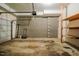Spacious garage with block walls, painted floors and convenient built-in wooden storage shelving at 244 Sweet Bay Pl, Carrboro, NC 27510