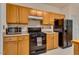 Kitchen features wooden cabinets and black appliances at 244 Sweet Bay Pl, Carrboro, NC 27510