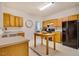 Kitchen boasts a central island, wooden cabinetry, and modern appliances at 244 Sweet Bay Pl, Carrboro, NC 27510