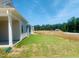 Spacious backyard showing surrounding properties and tree line at 28 Carteret Ct, Clayton, NC 27527