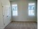 Bedroom with plush carpet and two windows offering ample natural light at 28 Carteret Ct, Clayton, NC 27527