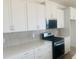 View of kitchen, featuring a gas range, stainless steel appliances, white countertops, and modern backsplash at 28 Carteret Ct, Clayton, NC 27527