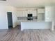 Spacious kitchen features white cabinets, a large island, stainless steel appliances, and wood flooring at 28 Carteret Ct, Clayton, NC 27527
