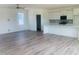 Open concept living room and kitchen with wood floors and large windows at 28 Carteret Ct, Clayton, NC 27527