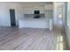 View of open concept living room featuring wood flooring and white kitchen with island at 28 Carteret Ct, Clayton, NC 27527