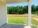 View from the patio, showcasing a lush green lawn and surrounding trees for privacy at 28 Carteret Ct, Clayton, NC 27527