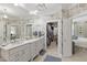 Elegant bathroom featuring dual vanities, ample storage, and access to a walk-in closet and bedroom at 2813 Market Bridge Ln # 104, Raleigh, NC 27608