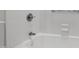 Close-up of a pristine white bathtub featuring tile surround and sleek fixtures at 2813 Market Bridge Ln # 104, Raleigh, NC 27608