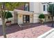 Building entrance showcasing a brick walkway, manicured landscaping, and double doors at 2813 Market Bridge Ln # 104, Raleigh, NC 27608