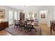 Elegant dining room featuring a chandelier, wooden table and chairs, with a view of the balcony at 2813 Market Bridge Ln # 104, Raleigh, NC 27608